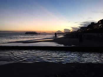 View of calm beach at sunset