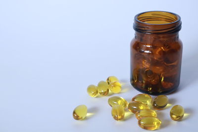 Close-up of glass of jar against white background