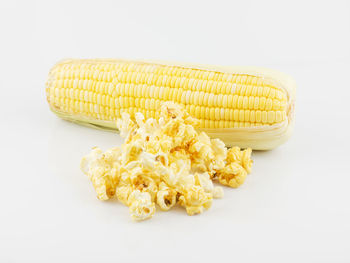 High angle view of yellow cake against white background