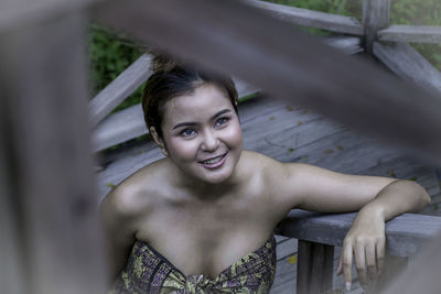 High angle view of thoughtful young woman seen through railing