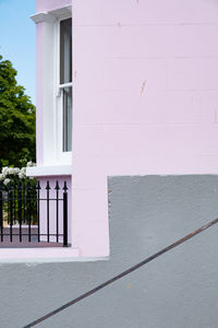Low angle view of pastel pink building