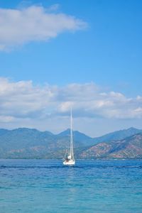 Sailboat sailing on sea against sky