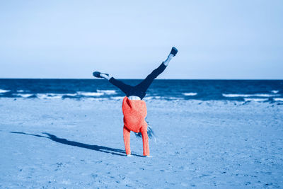 Full length of woman walking on beach