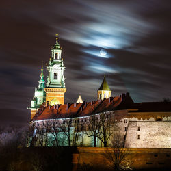 Low angle view of illuminated building against sky at night