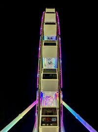 Low angle view of illuminated ferris wheel against sky at night