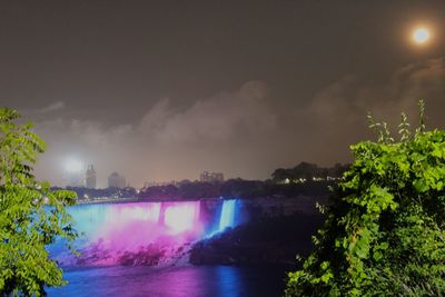 Scenic view of lake against sky at night