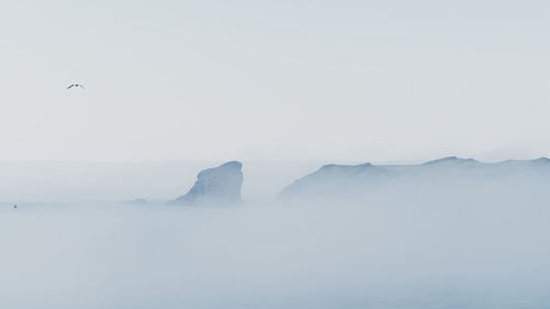 Scenic view of sea against sky during winter