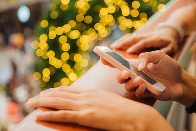 Close-up of woman holding mobile phone