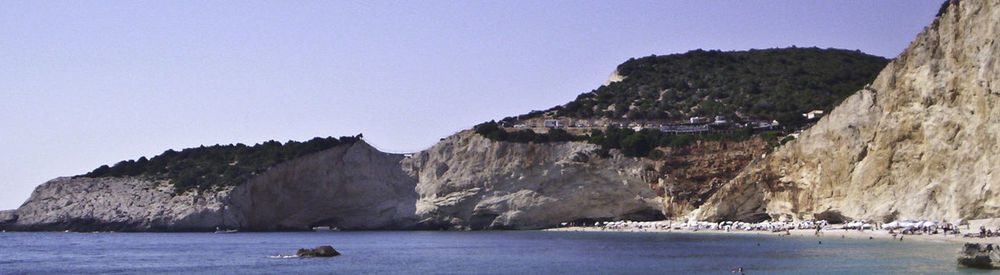 Scenic view of sea with mountain range in background