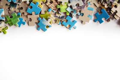 High angle view of multi colored pencils on white background