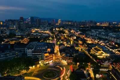 High angle view of illuminated buildings in city at night