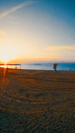 Scenic view of beach against sky during sunset