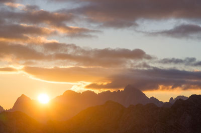 Scenic view of silhouette mountains against sky during sunset