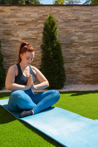 Young woman sitting on grass