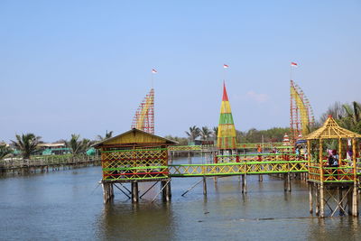 Traditional building by river against clear sky