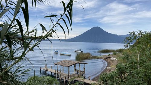 Scenic view of sea and mountains against sky