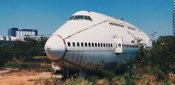 Abandoned airplane against clear blue sky