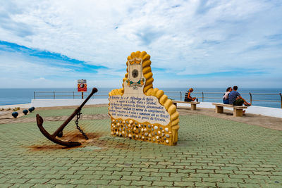 People on beach against sky