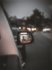 Reflection of man photographing car on windshield