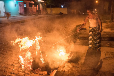 Rear view of woman standing at night