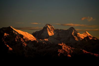 Scenic view of snowcapped mountains against sky during sunset