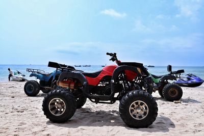 Tractor on beach against sky