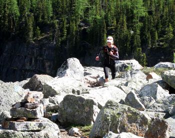 Man holding rock in forest