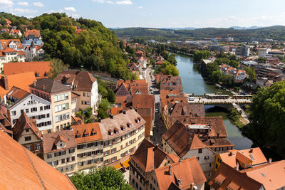 High angle view of river amidst buildings against sky