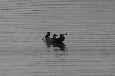 People in boat on lake