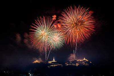 Low angle view of firework display at night