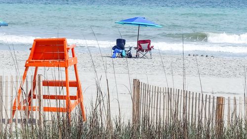 Chairs at sandy beach