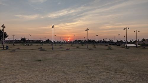 Scenic view of street against sky during sunset