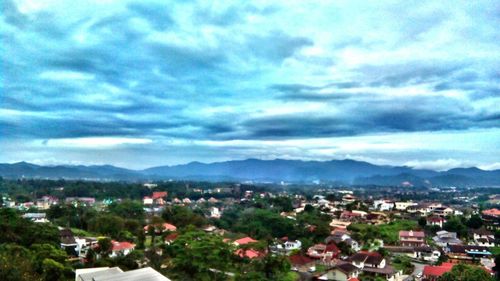 High angle view of town against cloudy sky