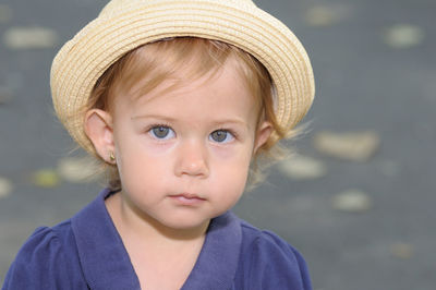 Close-up portrait of cute girl wearing hat