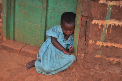 Boy sitting on stone