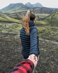 Rear view of woman standing on mountain