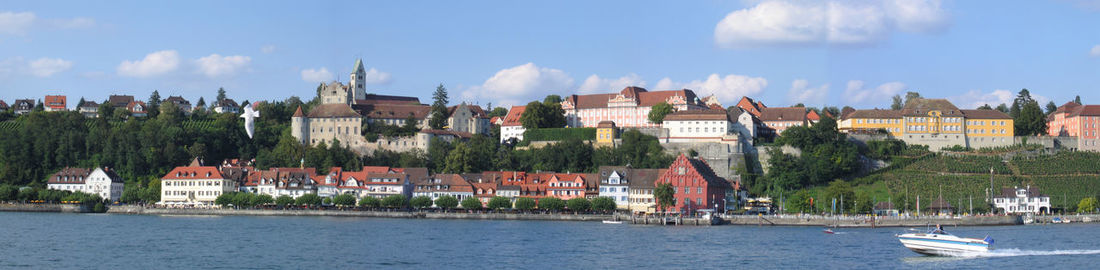 Panoramic view of townscape by buildings against sky