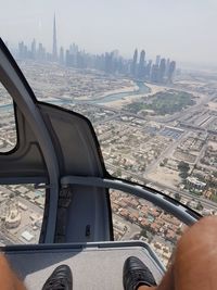 Close-up of airplane flying over river in city