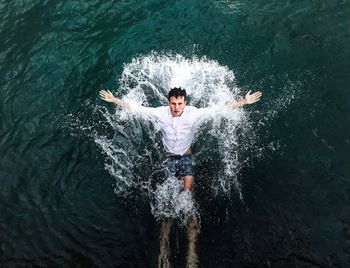 Young man swimming in sea