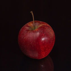 Close-up of apple against black background