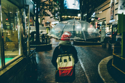 Rear view of woman on road in city