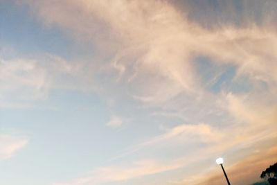 Low angle view of silhouette street light against sky