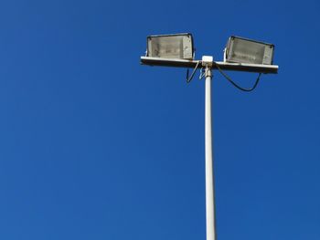 Low angle view of street light against clear blue sky