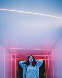 Young woman against blue sky