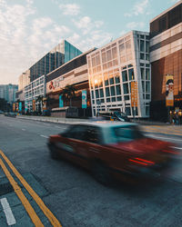 Blurred motion of road in city against sky