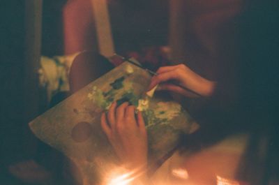 Close-up of woman holding hands on table