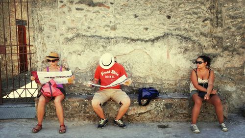 Full length of woman standing by railing