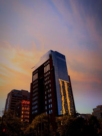 Low angle view of buildings against sky during sunset