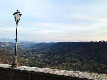Street light and mountains against sky