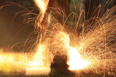 Close-up of fireworks on field at night